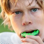 Boy putting in his sports mouth guard