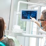 dentist pointing out signs of a cavity on dental x-ray