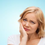 woman with toothache needs emergency dental care