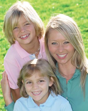 Family smiling outside