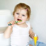 Little Baby Girl Holding Toothbrush