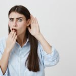 Woman covering mouth