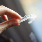 Woman holding dental aligner